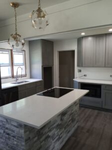 White kitchen countertops and gray cabinets